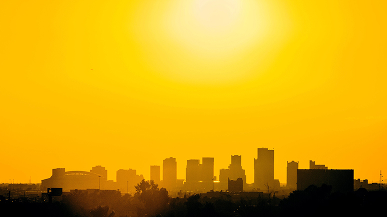 Cityscape silhouette againts a golden sky.